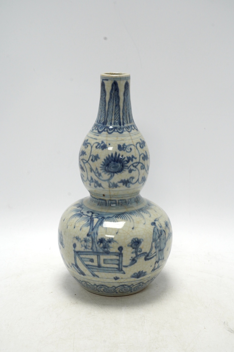 A Chinese blue and white double gourd vase, 28cm high. Condition - fair, chipping to base